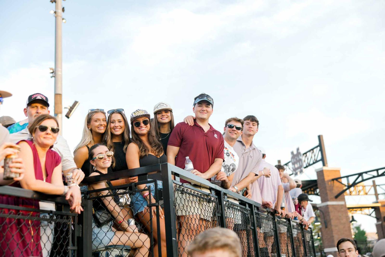 Group of students in left field lounge at Mississippi State baseball.