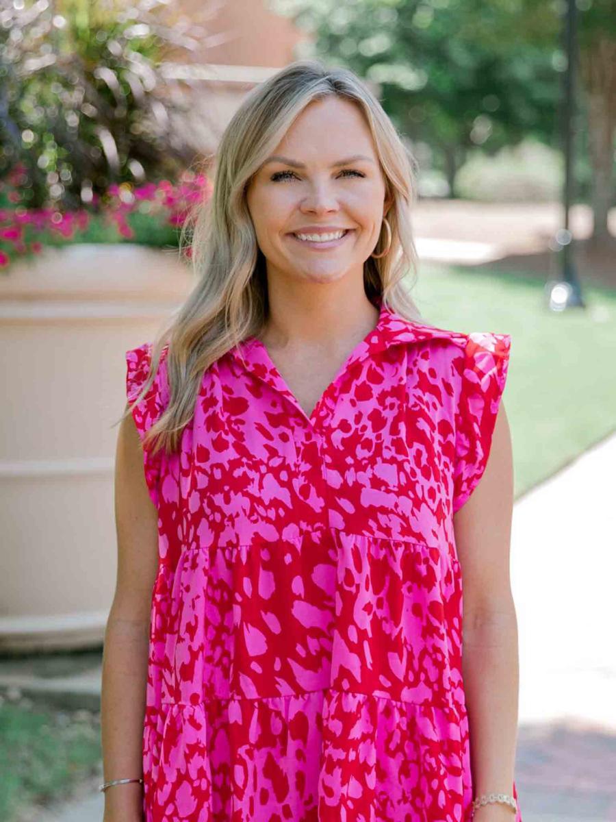 Mississippi State University professional headshot of a woman with blonde hair wearing a pink dress.