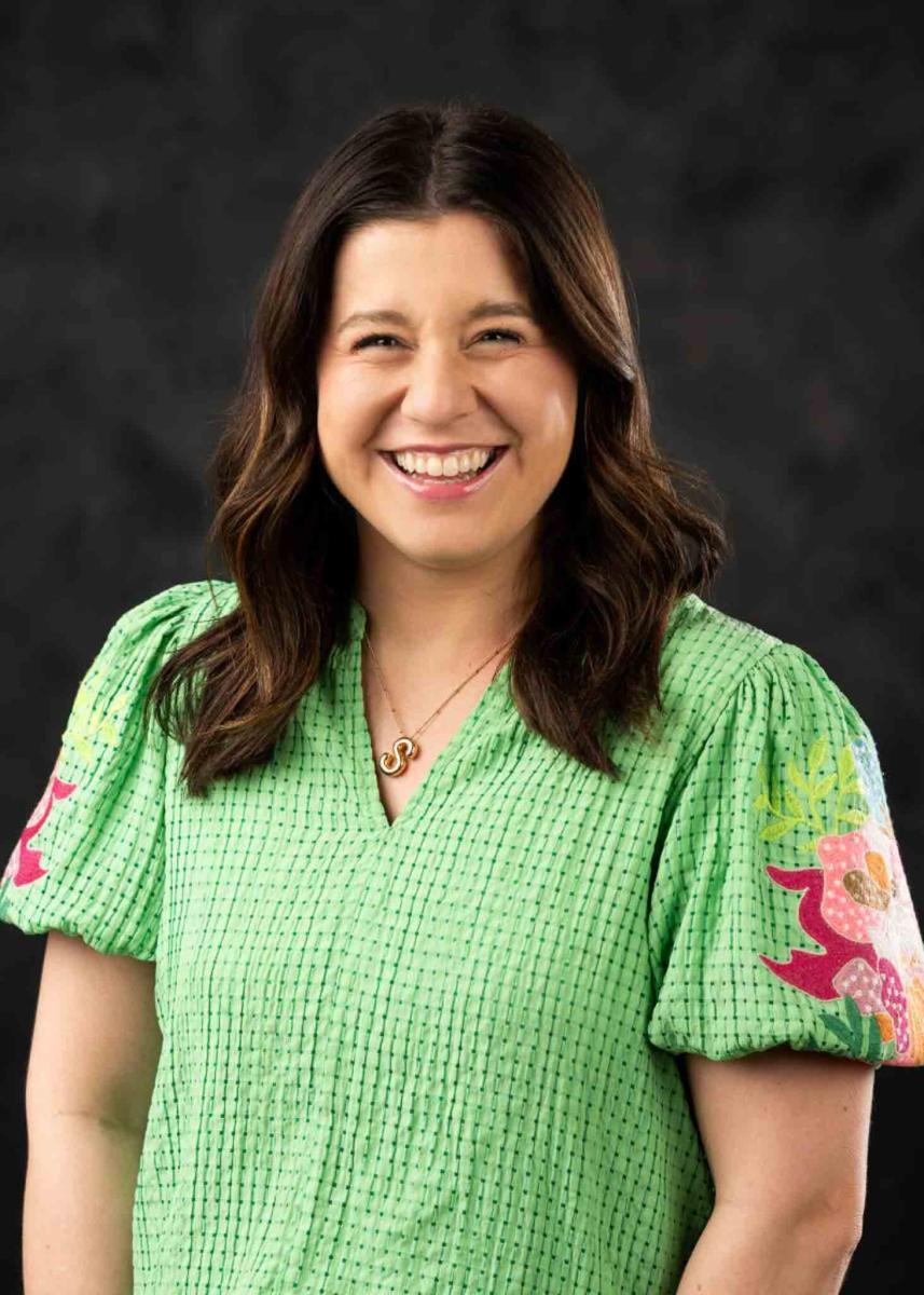 Mississippi State University professional headshot of a woman with brown hair wearing a green top.