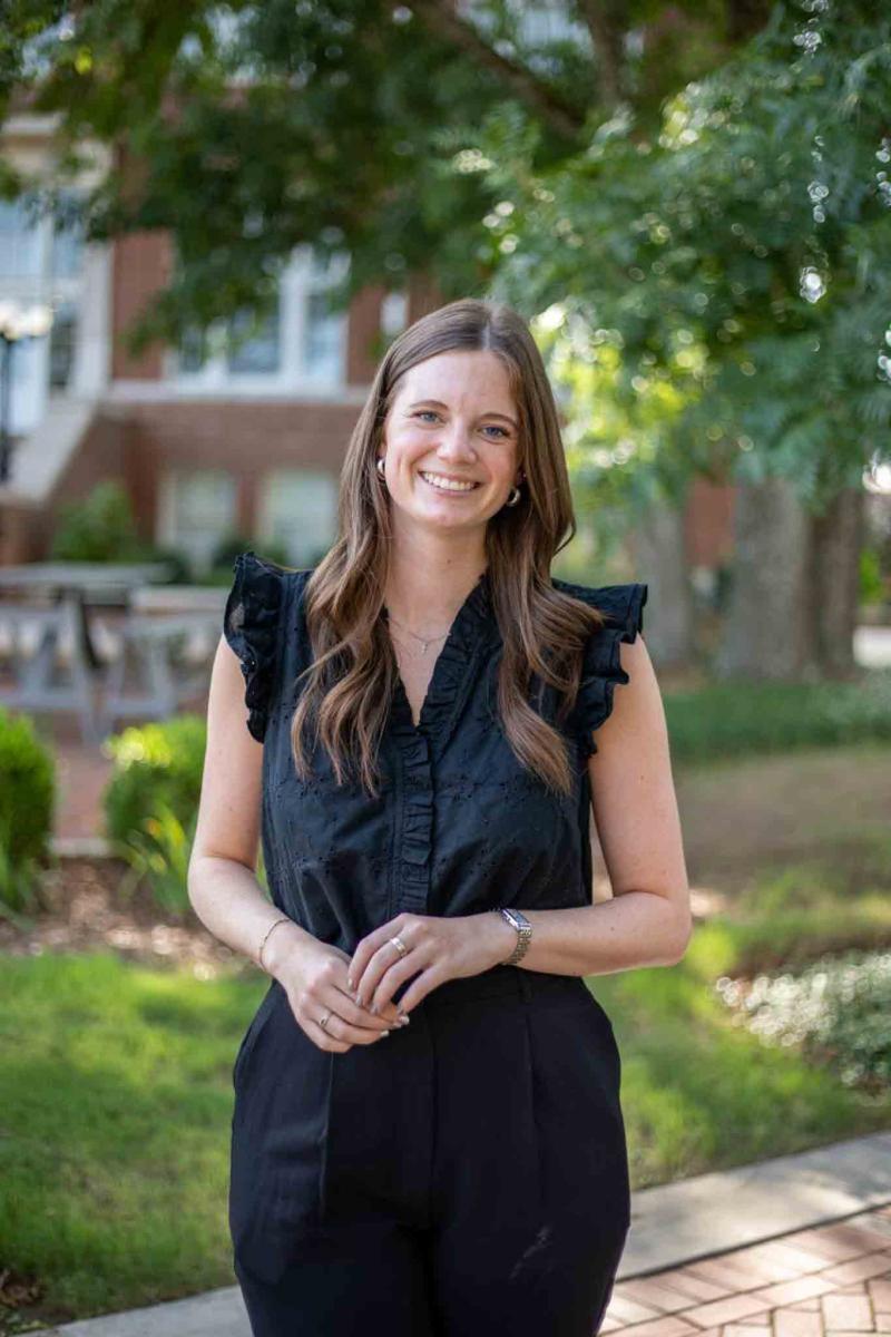 Mississippi State University professional headshot of a woman with long hair wearing a black dress. 